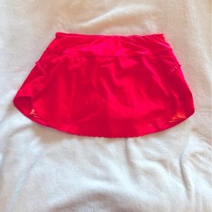 Neon pink tennis skirt with laser cutouts and ruffle detail. Size medium
